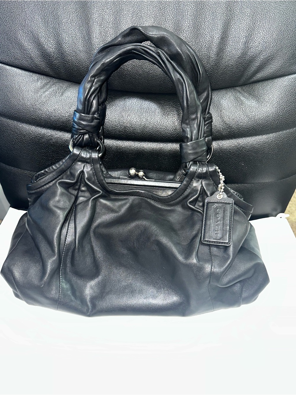 Coach Ergo Parker soft leather Kisslock hobo handbag with silver hardware.